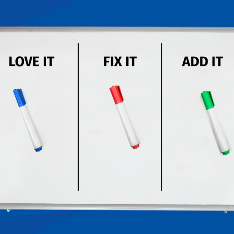 A whiteboard with a silver frame is centered on a blue geometric background. The board is divided into three vertical columns labeled "LOVE IT," "FIX IT," and "ADD IT," with a corresponding blue, red, and green dry-erase marker in each section.