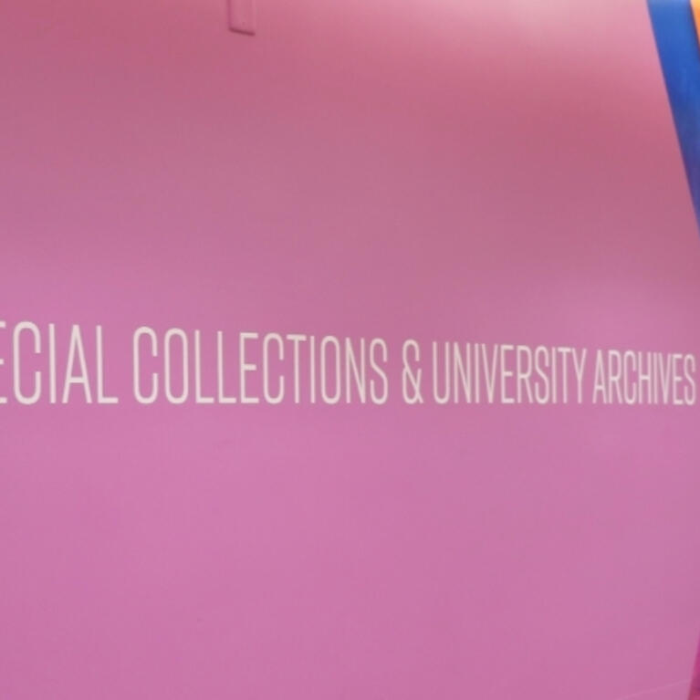 Large white number 4 and text reading "SPECIAL COLLECTIONS & UNIVERSITY ARCHIVES" on a bright purple wall with diagonal blue and orange chevron accents.