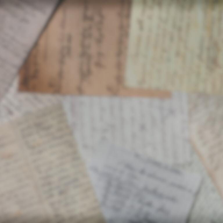 Blurry photos of paper on a desk.
