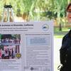 Student standing near their poster