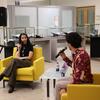 Laila Lalami and Klein Librarian Dr. Phoenix Alexander sit across from each other in yellow armchairs, each holding a microphone in conversation.
